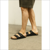 Birkenstock Arizona Svart BirkoFlor sandals with soft footbed worn by a person, showcasing a stylish and comfortable fit.