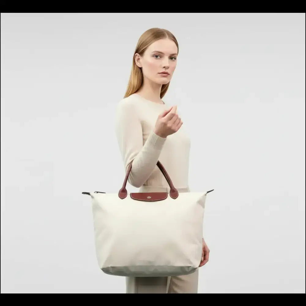 Longchamp Le Pliage L – Paper White Large Tote Bag held by a model showcasing its elegant and practical design.